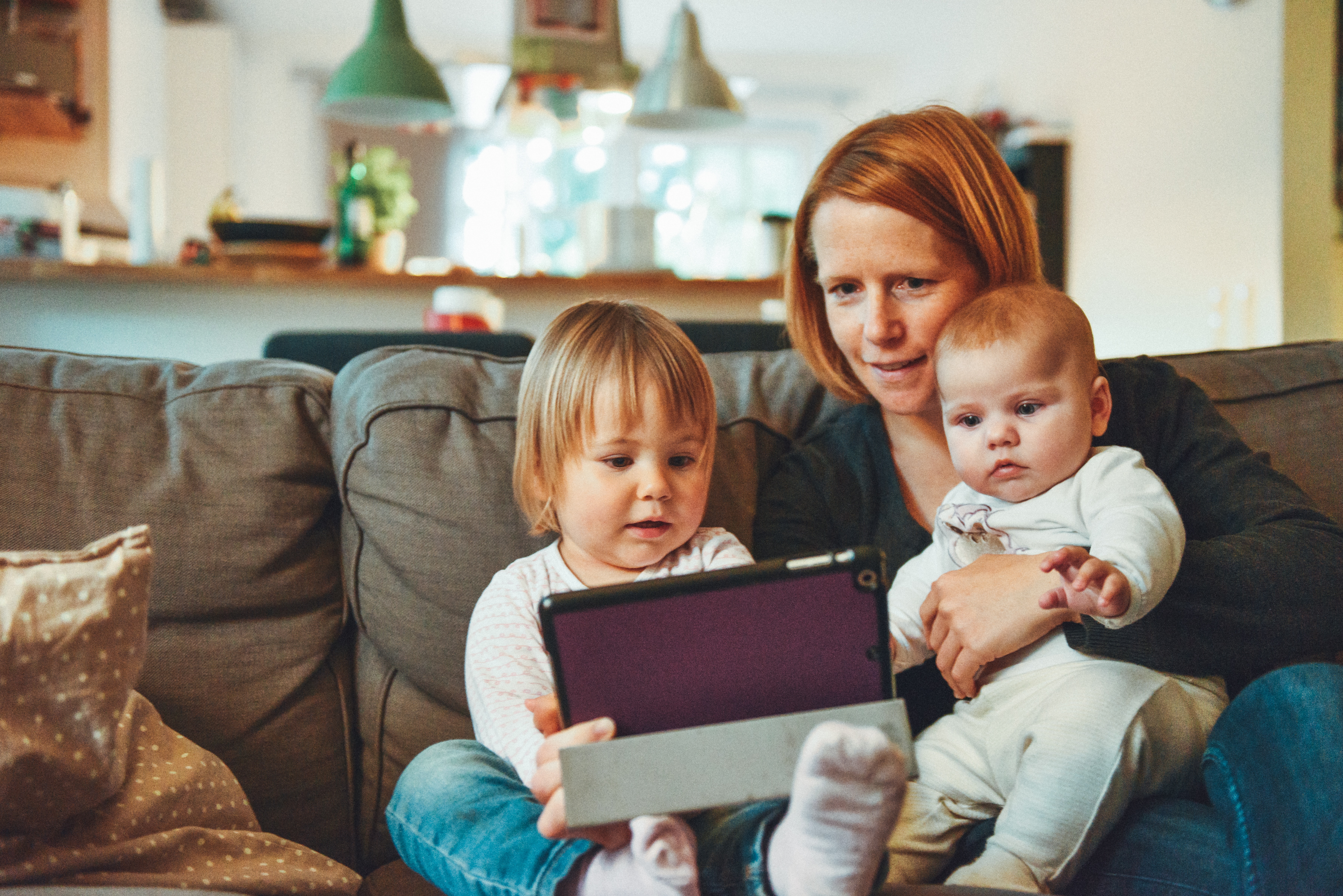 Mother on tablet with children